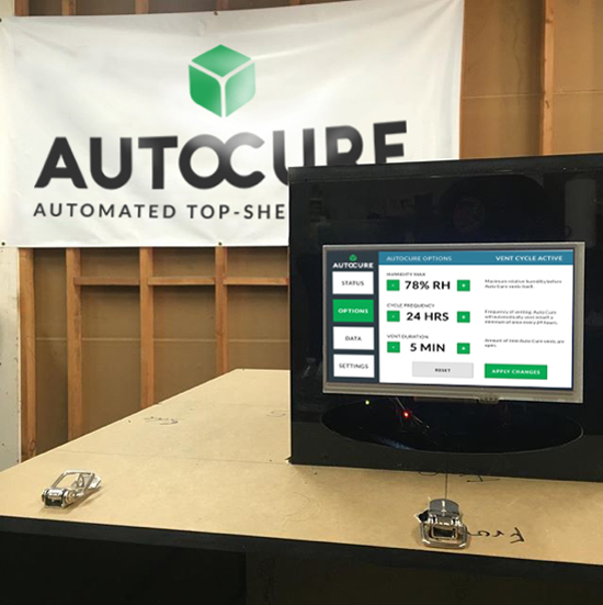 an Auto Cure unit with banner behind